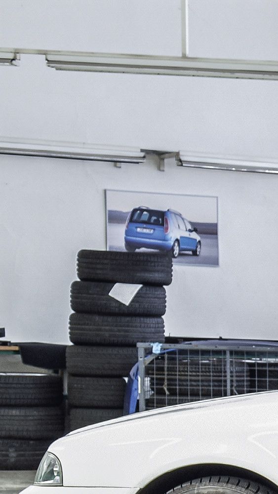 Ein Škoda Mechaniker in der Werkstatt zeigt einem Kunden die Bremsscheiben